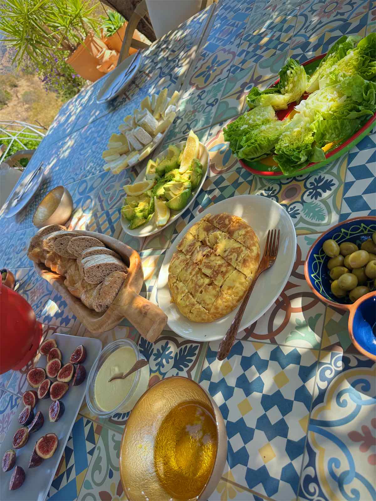 Dishes of shared food on a tiled table