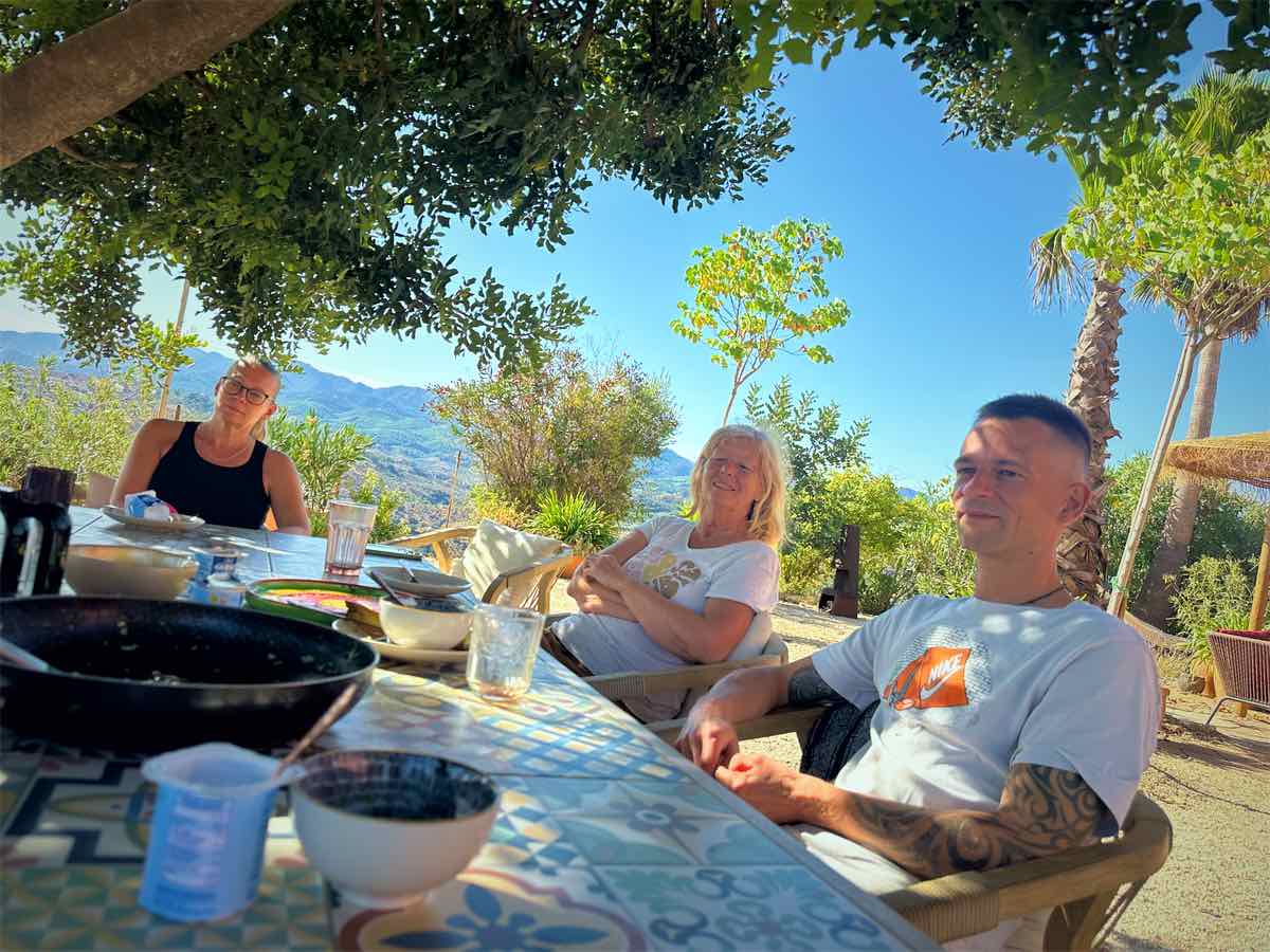 Smiles and easy conversation at the table under the tree